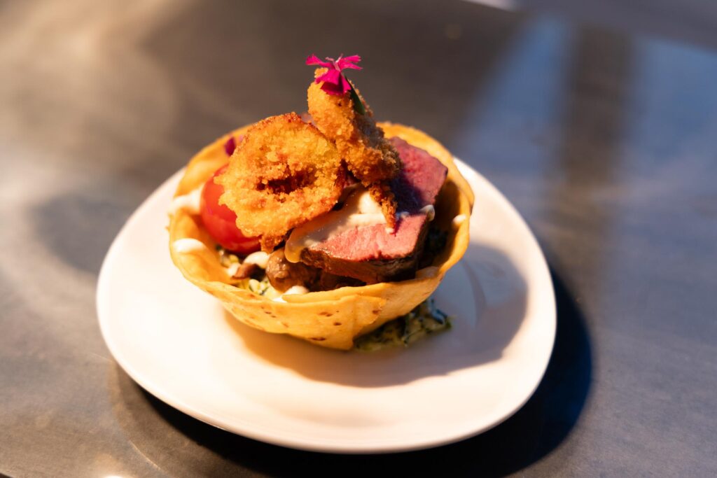 Delicious gourmet dessert with crispy toppings and fresh fruit, served in a waffle bowl.