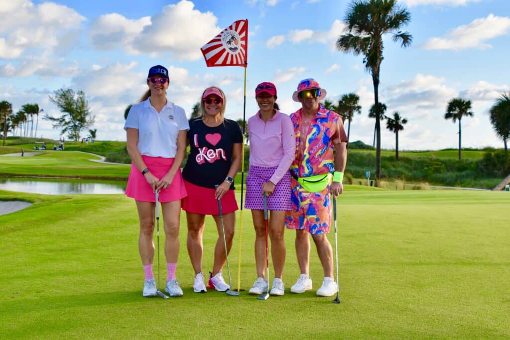 Golf people at Quantum House charity event in sunny Florida, wearing colorful outfits.