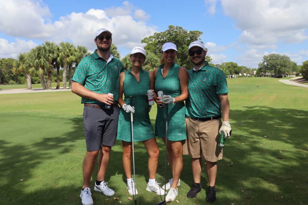Group of four friends enjoying a golf day at Quantum House charity event.
