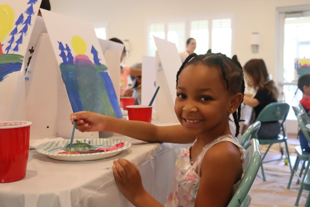Child painting at Quantum House art workshop.